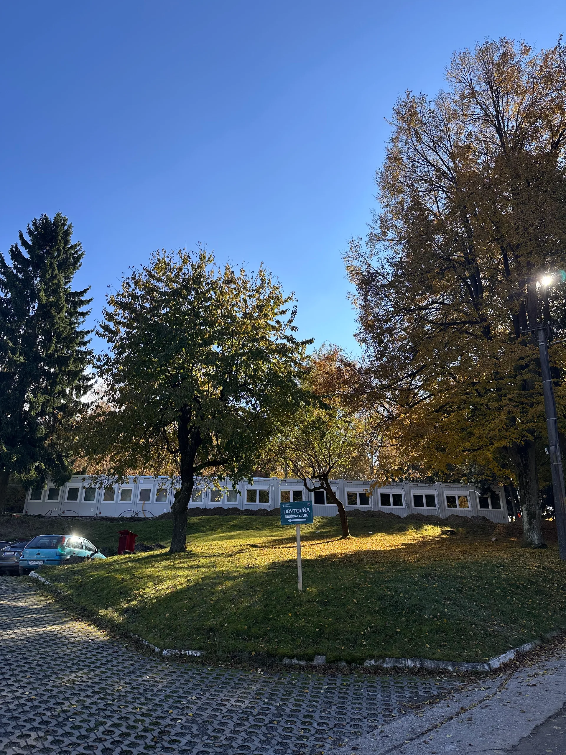 ARMADA framework: outdoor row of white containers at site, autumn light, treeline behind.