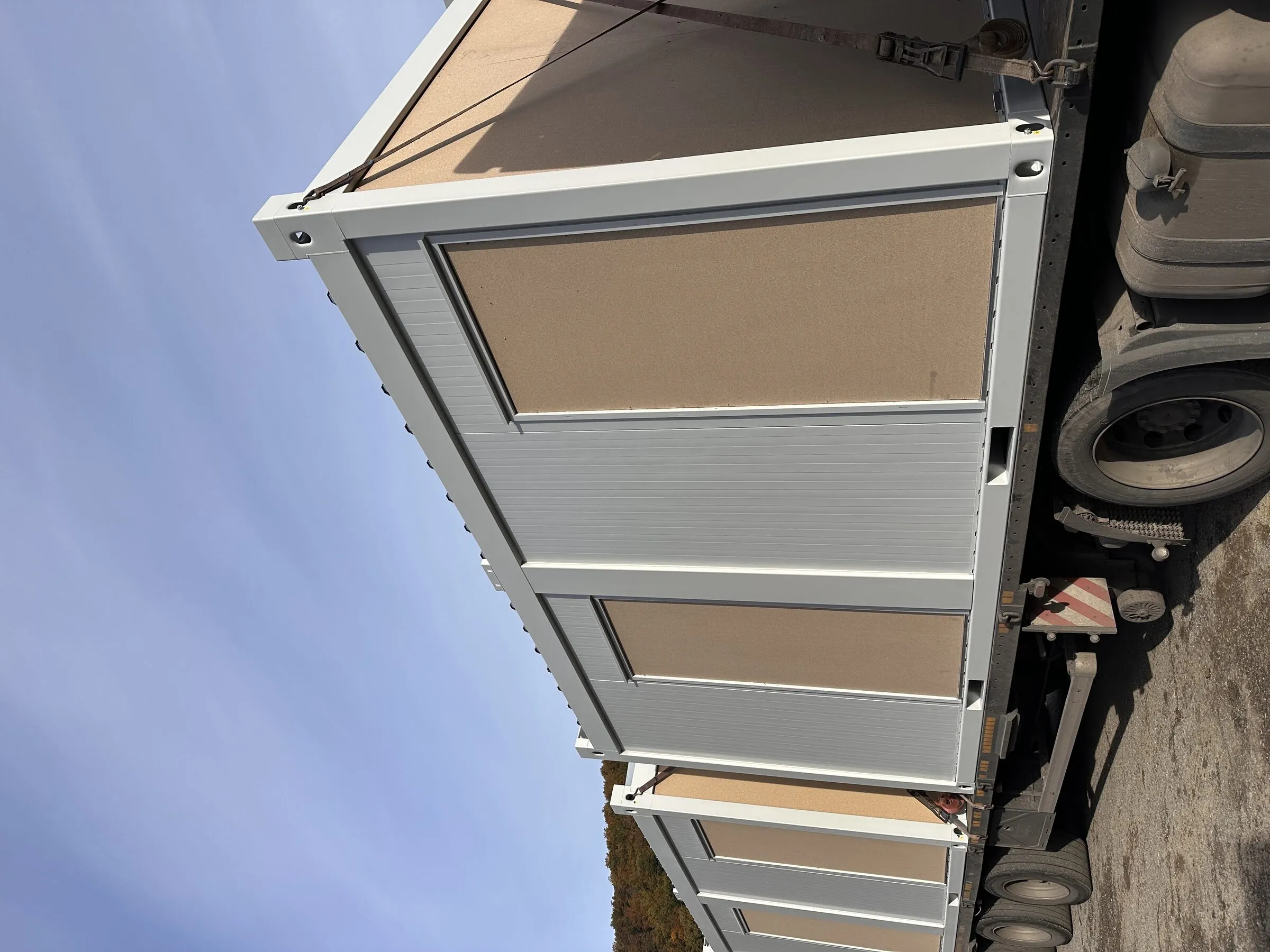 Beige defence container loaded on a trailer for transport