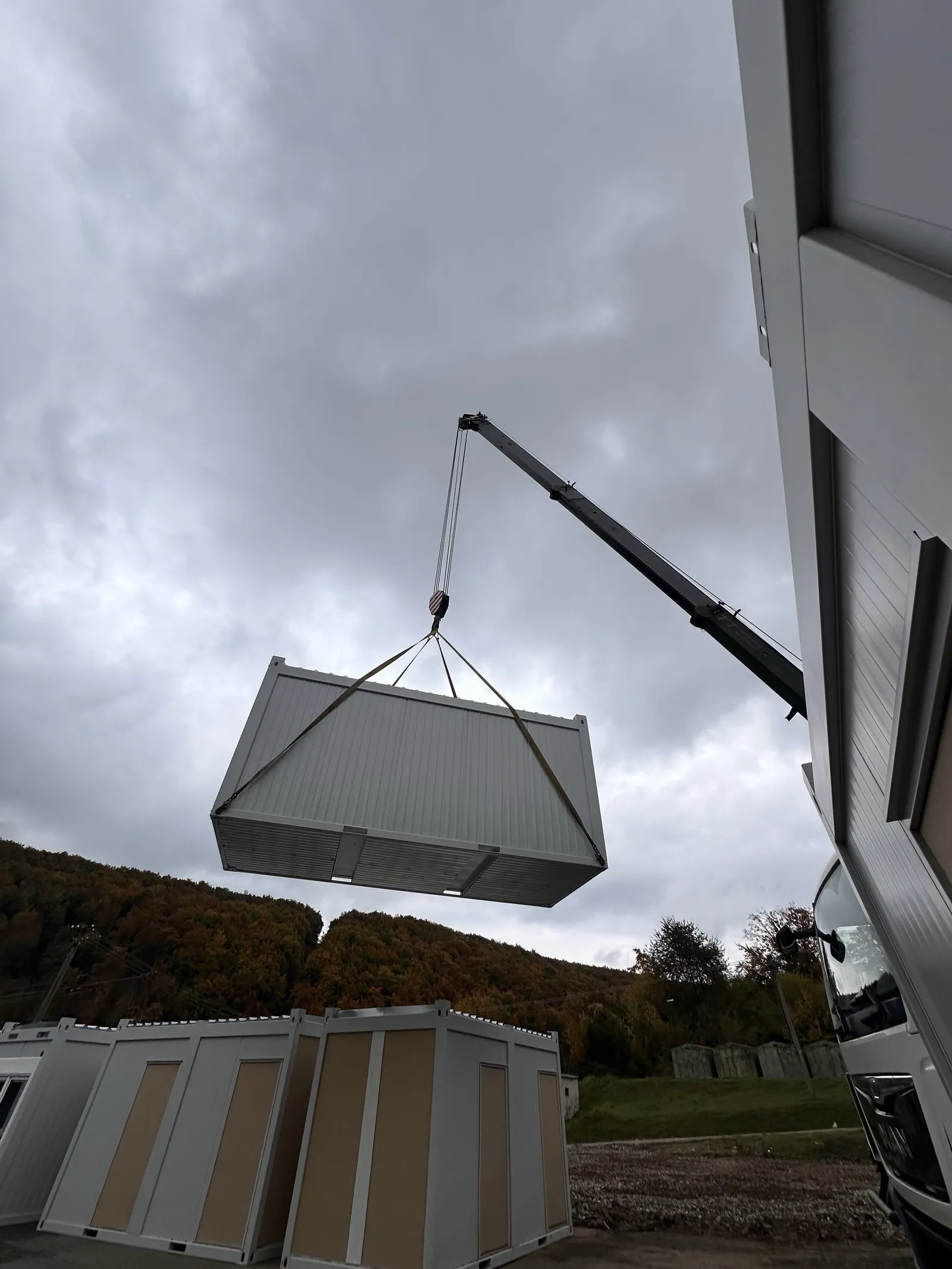 Container module hoisted by a crane at the worksite