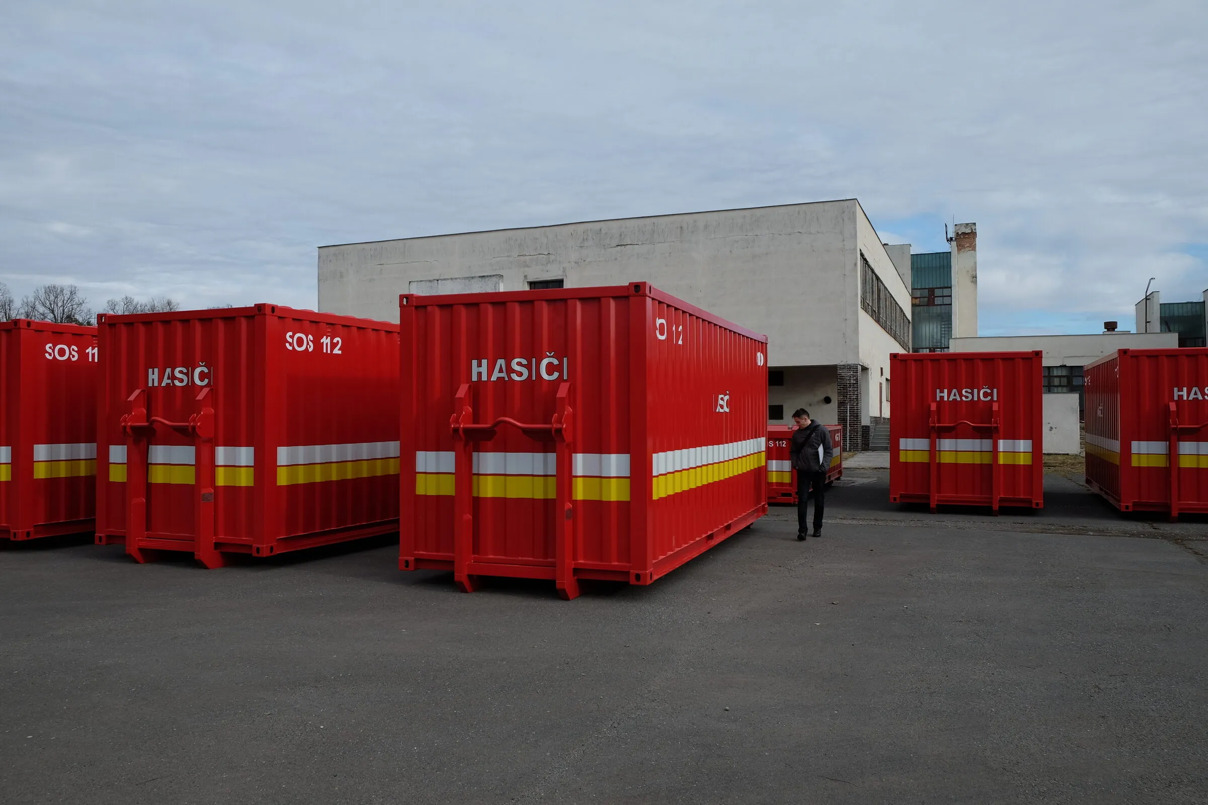 Feuerwehrmodule auf einem Depothof mit einer Person, die zwischen ihnen geht