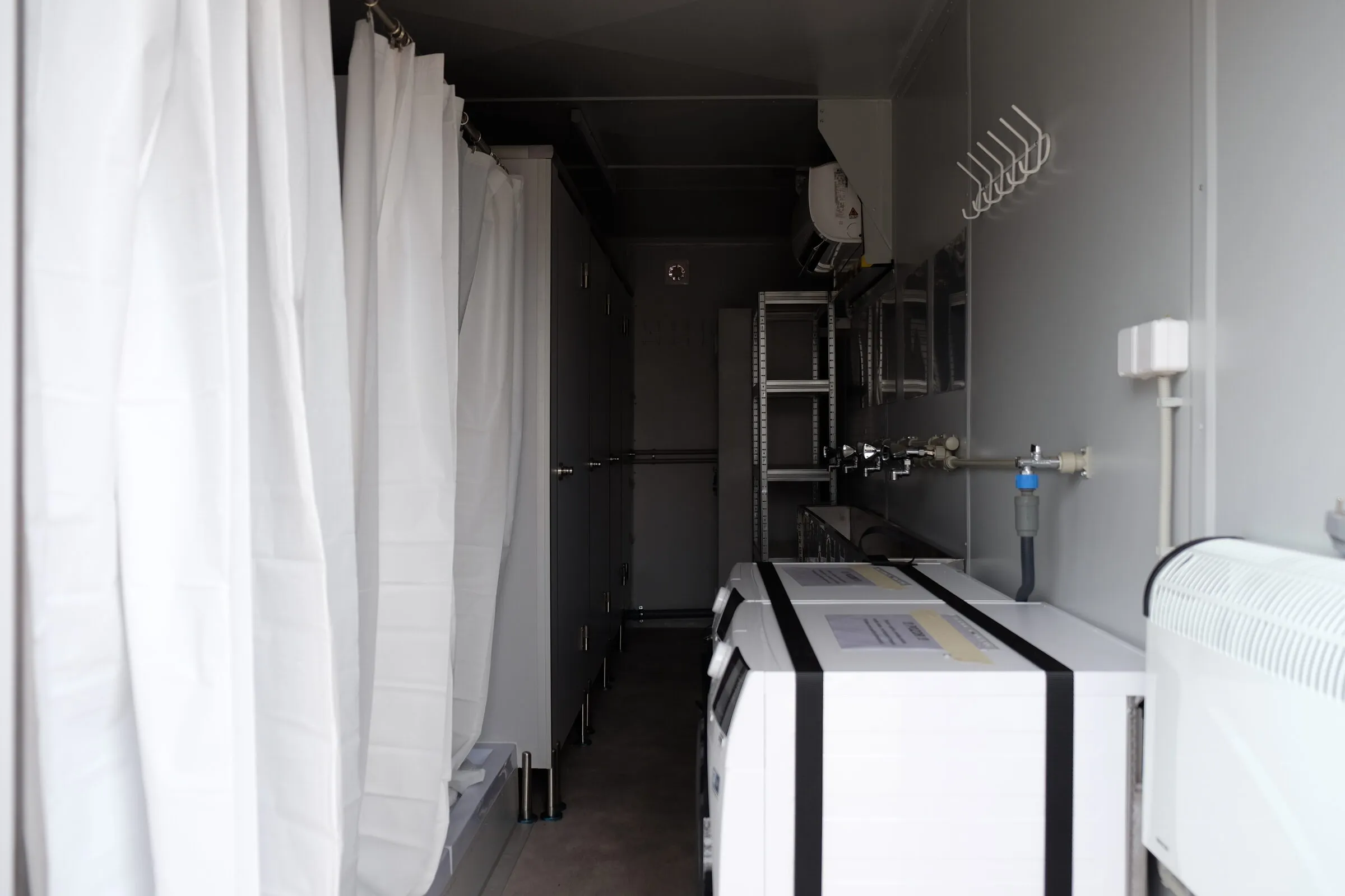 Laundry module interior with washing machines in a fire-service unit