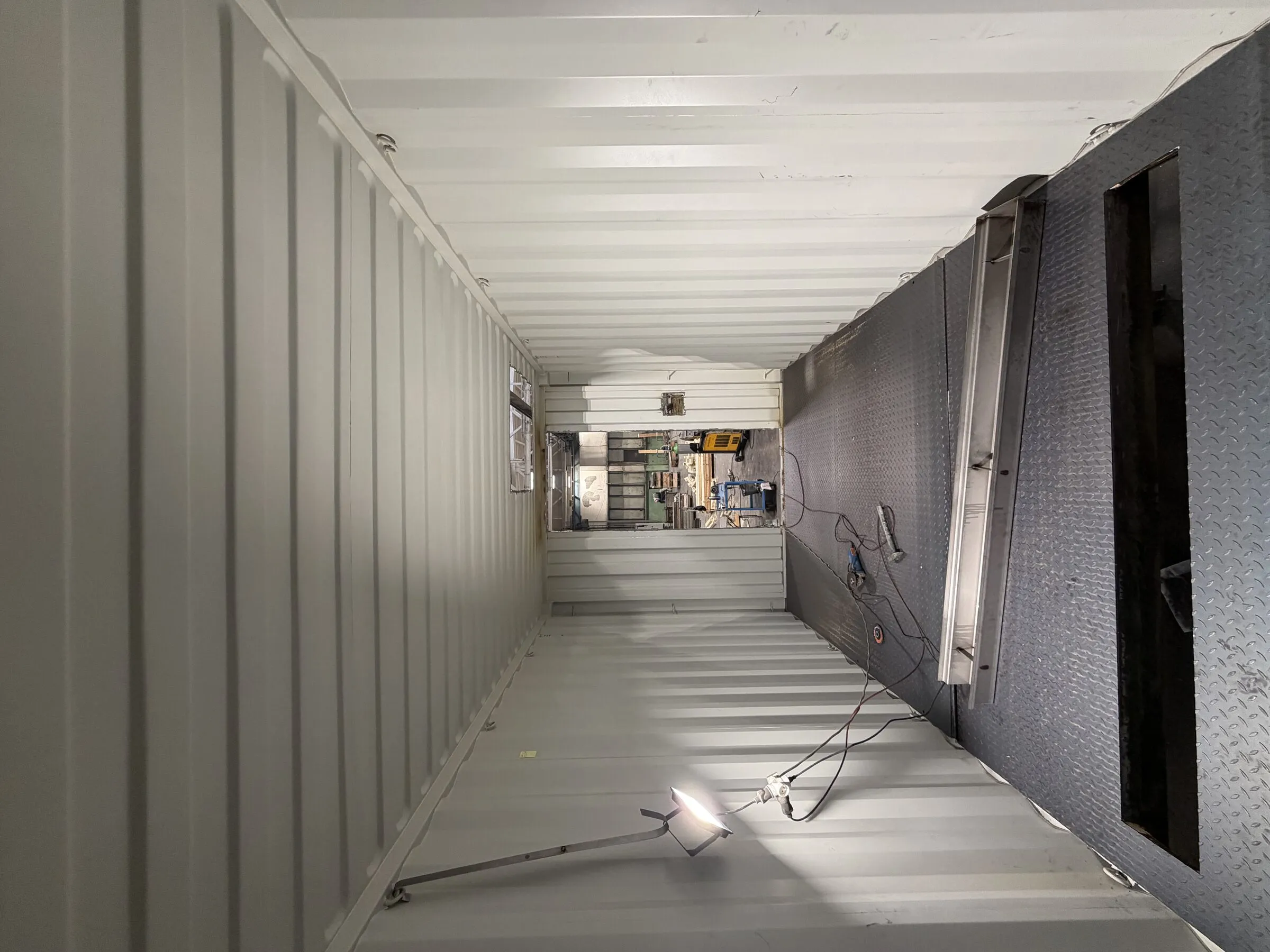 Corridor floor hatch inside a module during production, from the fire-training programme