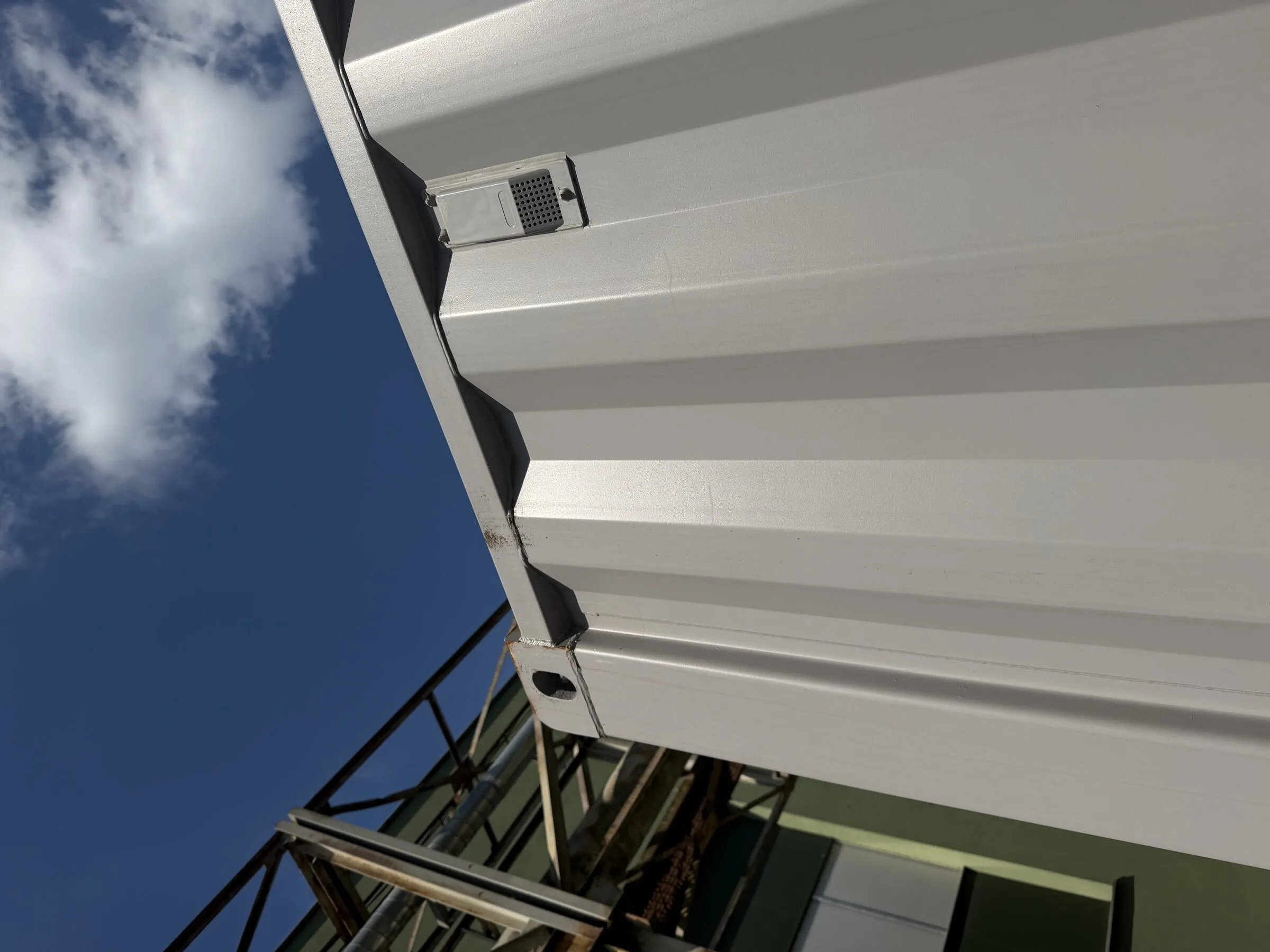 Corner and roof detail of a white resort container