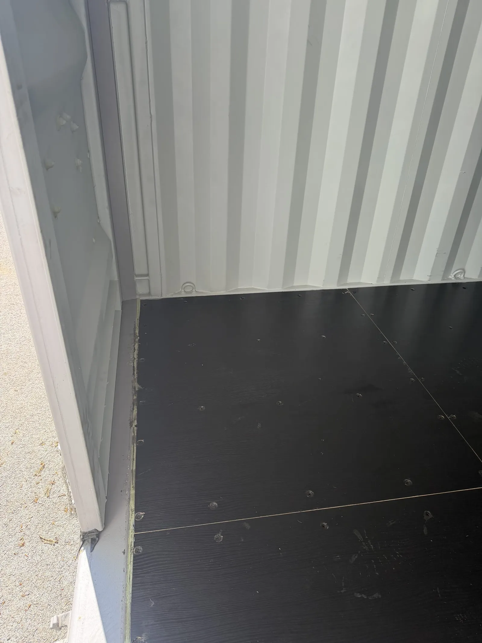 Black floor inside a white resort container
