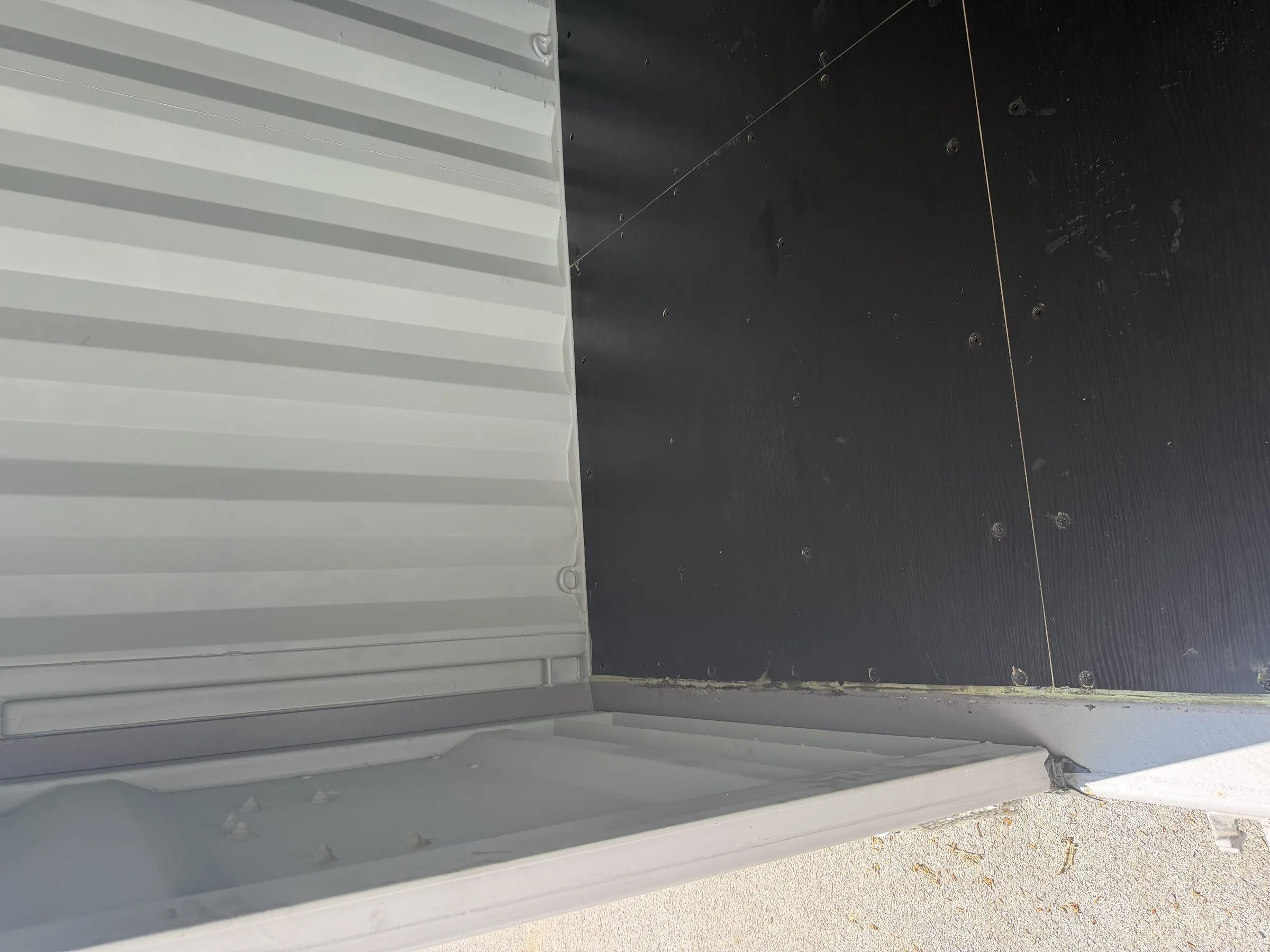 Black floor inside a white resort container