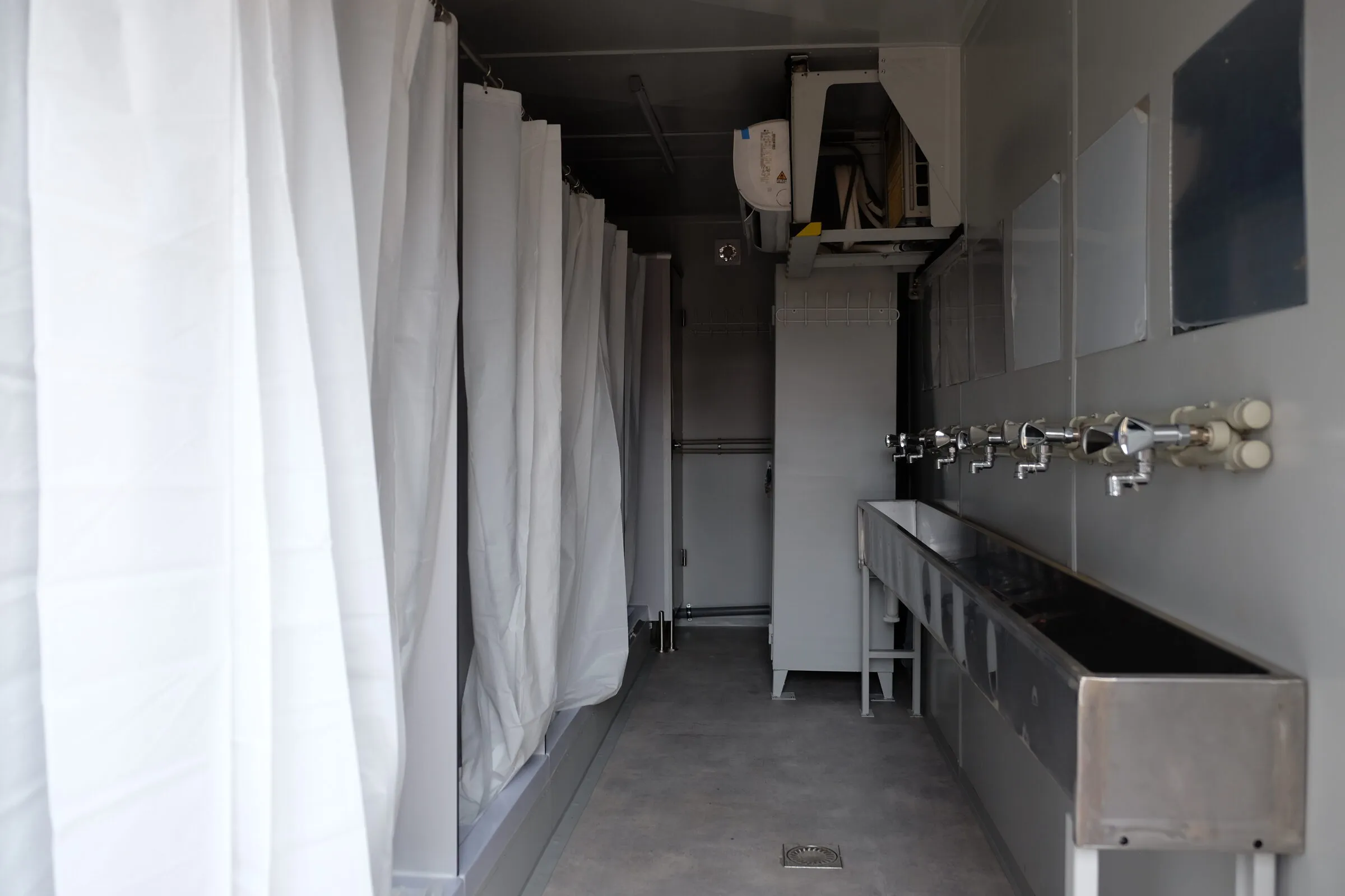 Trough washbasin run in a washroom module