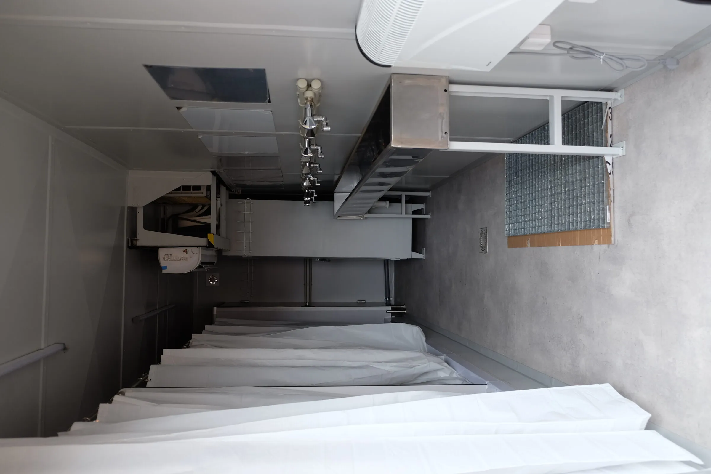 Second view of a stainless-lined washroom interior