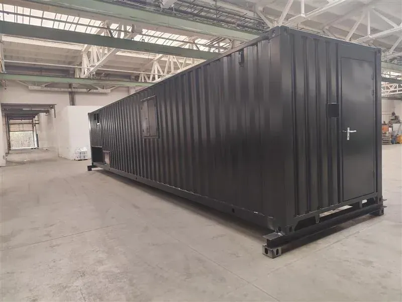 Side of a black 40 ft training module with a door, in the production hall