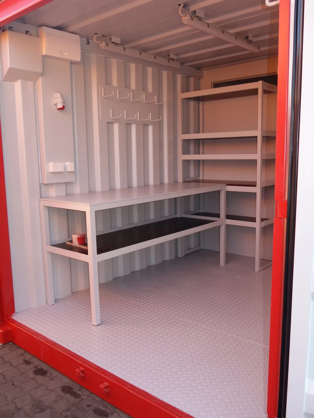 Workshop module interior with tool storage and benches